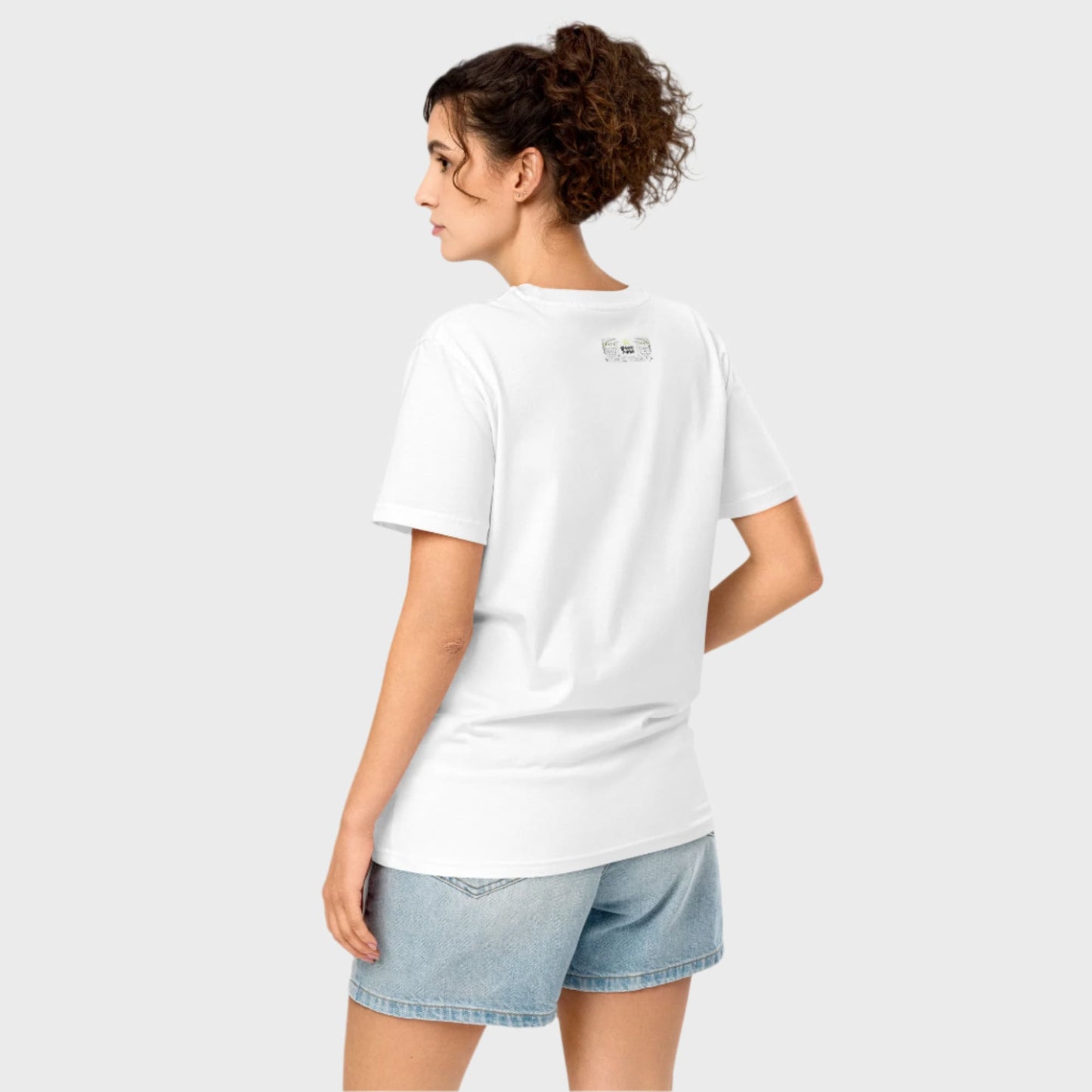 Woman from behind wearing white HONESTY tshirt and shorts