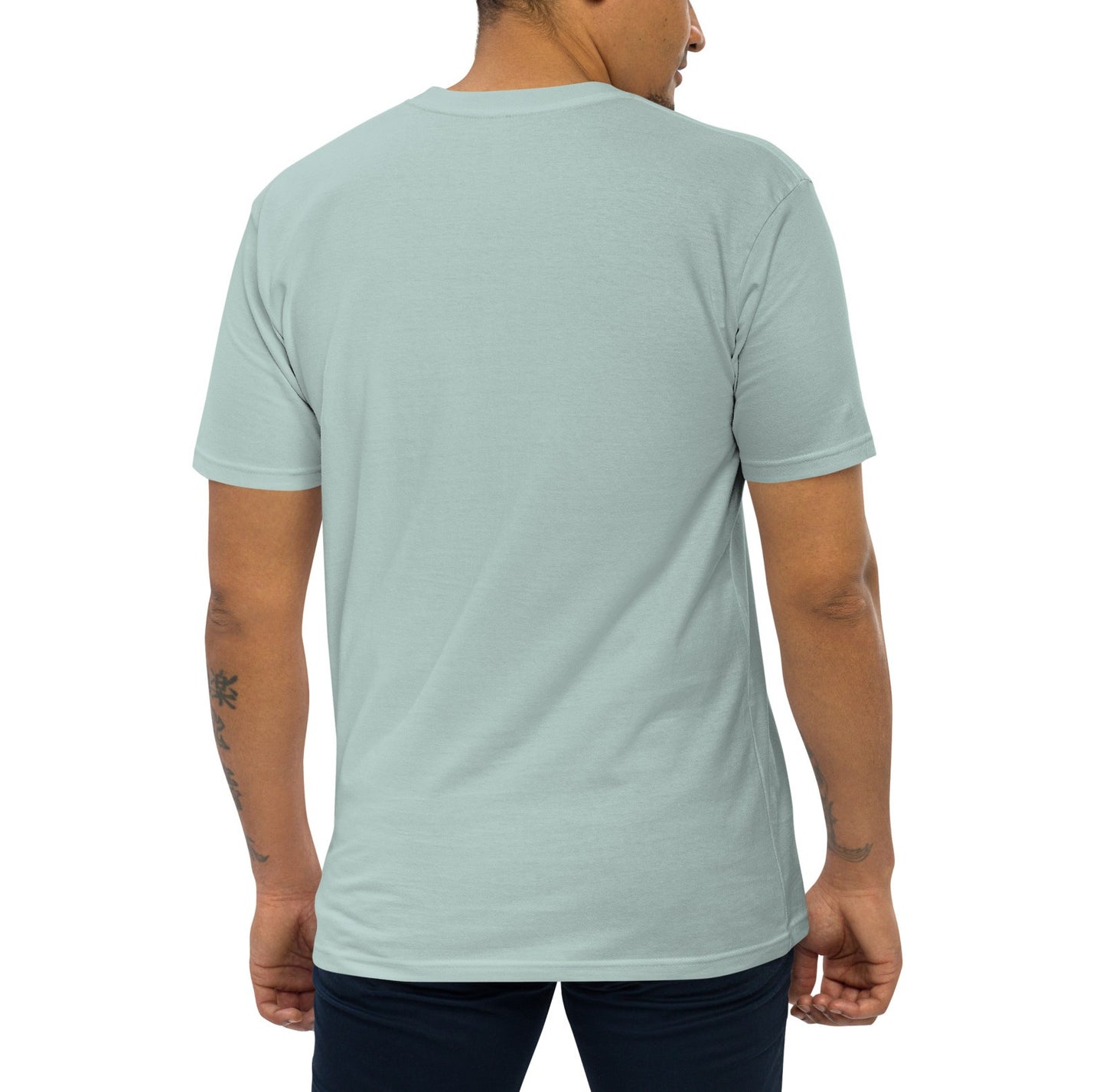Man wearing agave colored shirt from behind on plain background