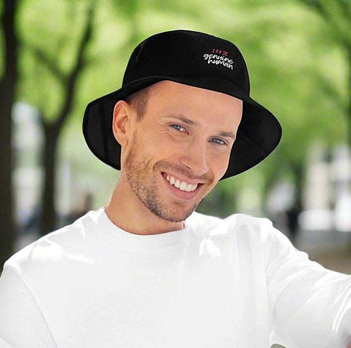 Happy looking man wearing black hat with text 100% genuine human in nature
