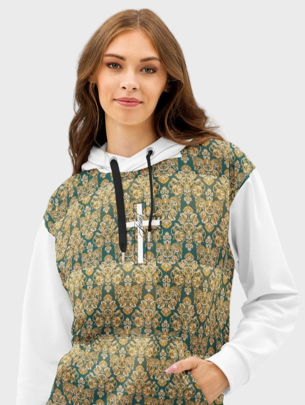 Portrait of woman wearing a hoodie with a ornamented pattern and a white cross at the center chest