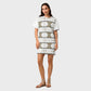 Woman wearing a patterned dress on a plain background