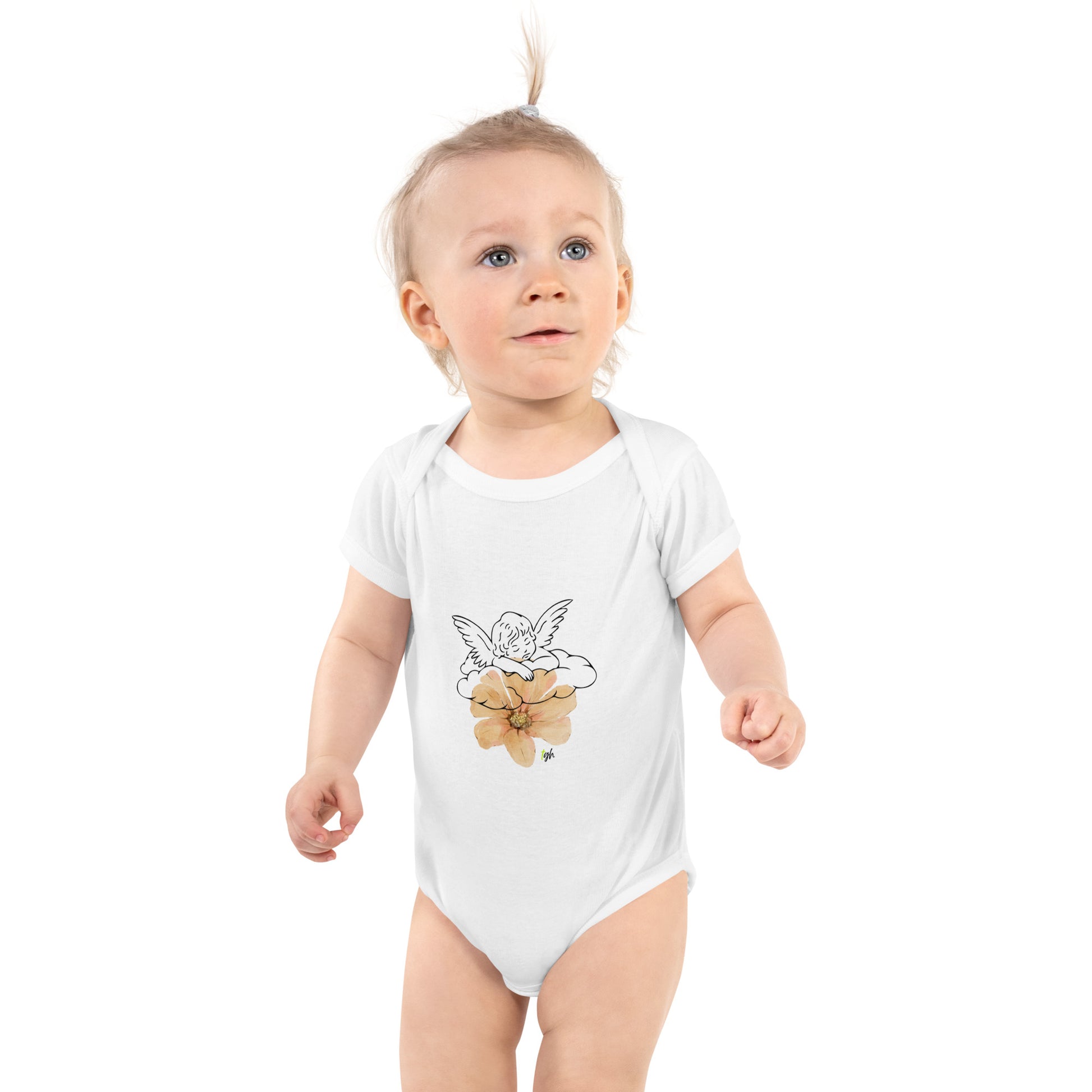 Baby wearing white onesie with angel and poppy flower design