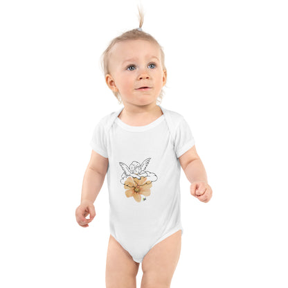 Baby wearing white onesie with angel and poppy flower design