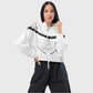 Woman wearing a white faith based windbreaker jacket with black text and graphics