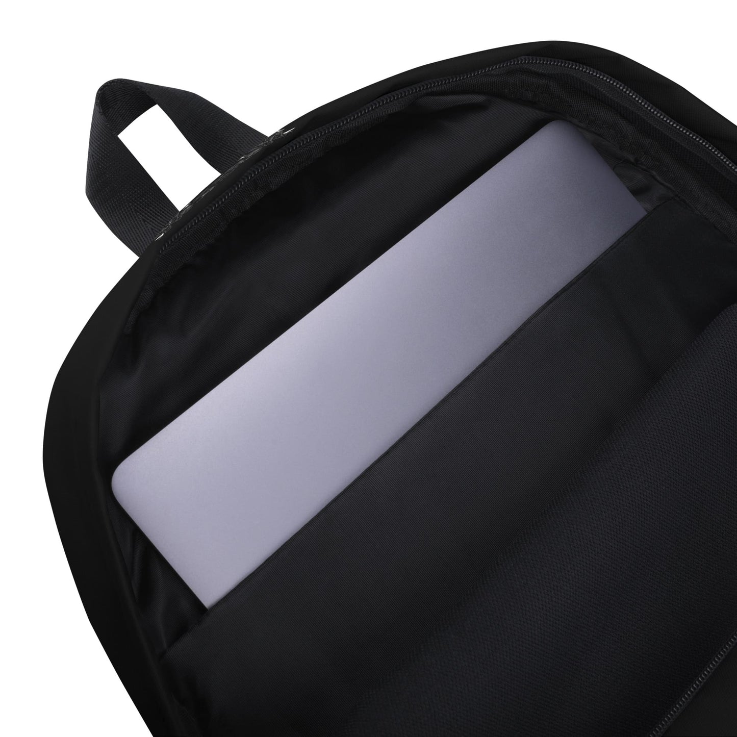 Black interior of a backpack with laptop inside