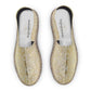 Pair of beige espadrilles with floral pattern on a white background