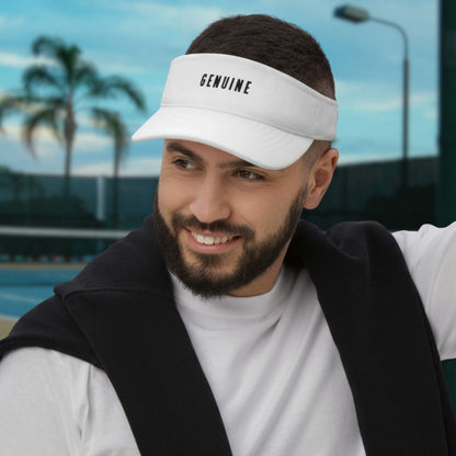 Smiling man wearing white visor hat with letters GENUINE on tennis court