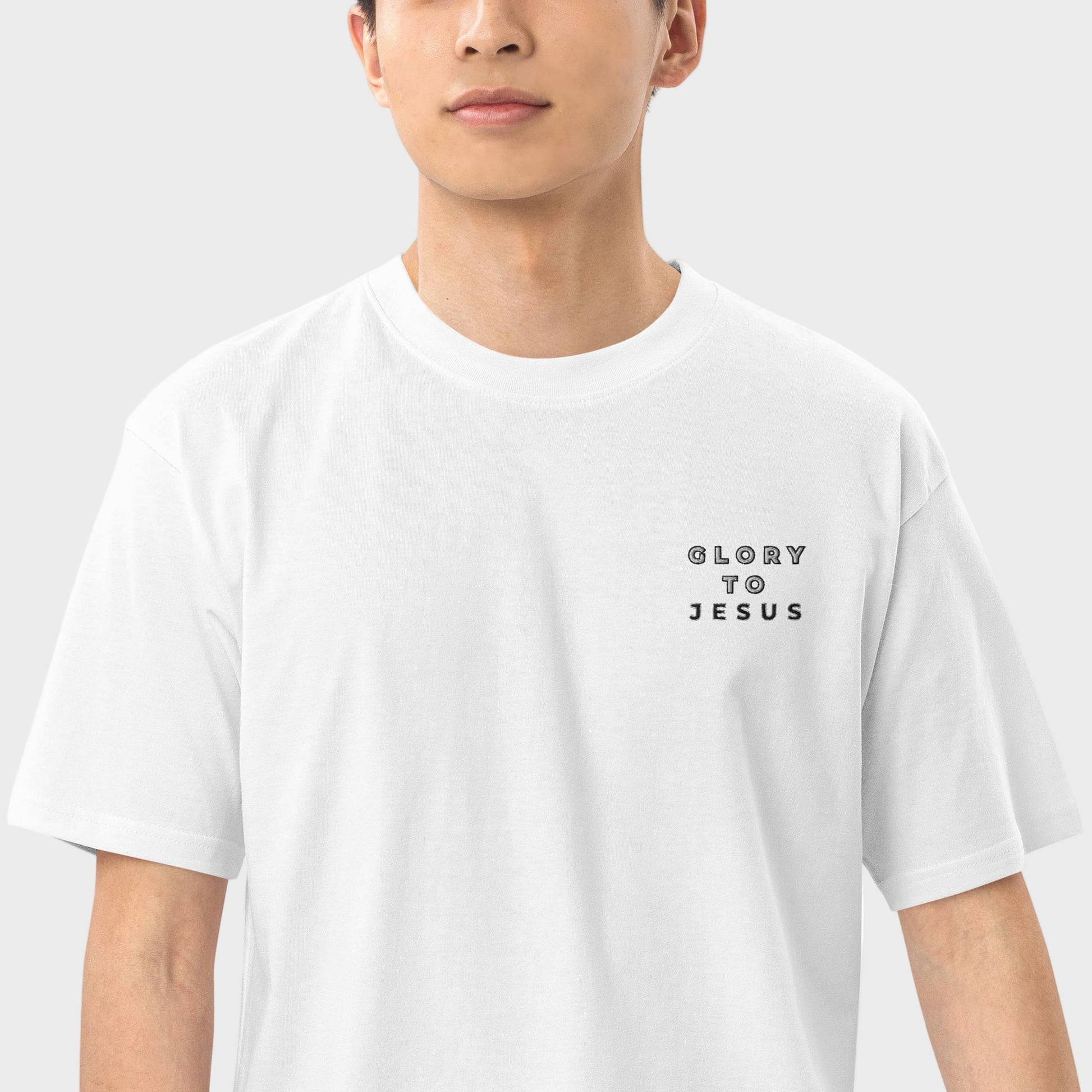 Close up of a man wearing a white Christian tshirt with letters Glory to Jesus