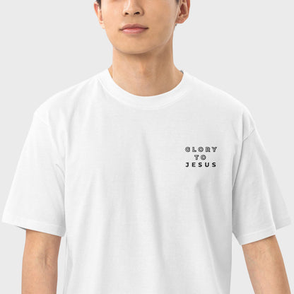 Close up of a man wearing a white Christian tshirt with letters Glory to Jesus