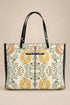 A  tote bag featuring a vintage-style lion and floral damask pattern in muted yellow, green, and brown on an off-white background, with black leather handles and trim.