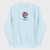 Light blue hoodie with a red rose graphic and text on a light gray background