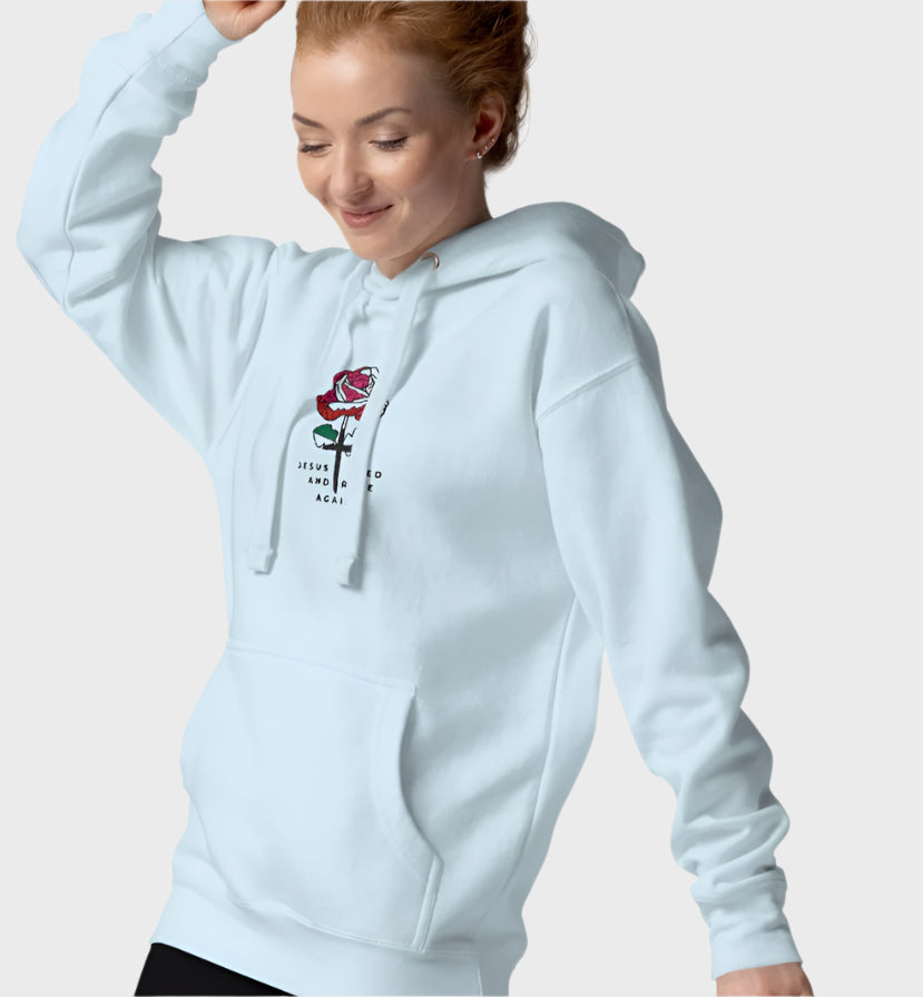 Woman wearing light blue hoodie with rose graphic in the center