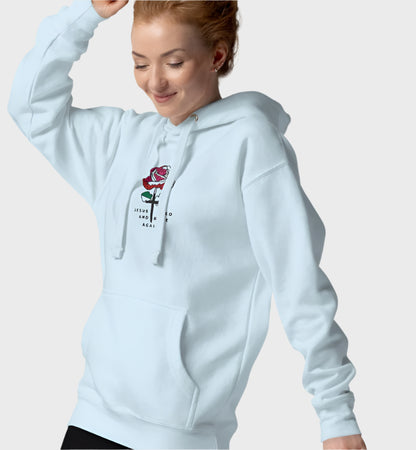 Woman wearing light blue hoodie with rose graphic in the center