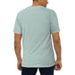 Man wearing agave colored shirt from behind on plain background
