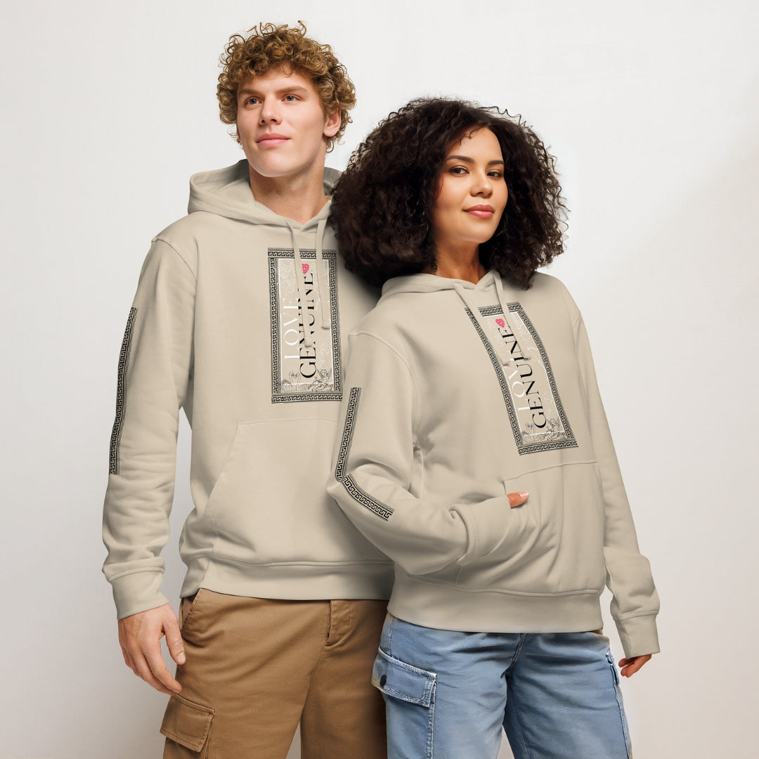 Two people wearing matching beige hoodies with a logo on a plain 