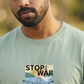 Man wearing a t-shirt with 'Stop the War Now' graphic design.