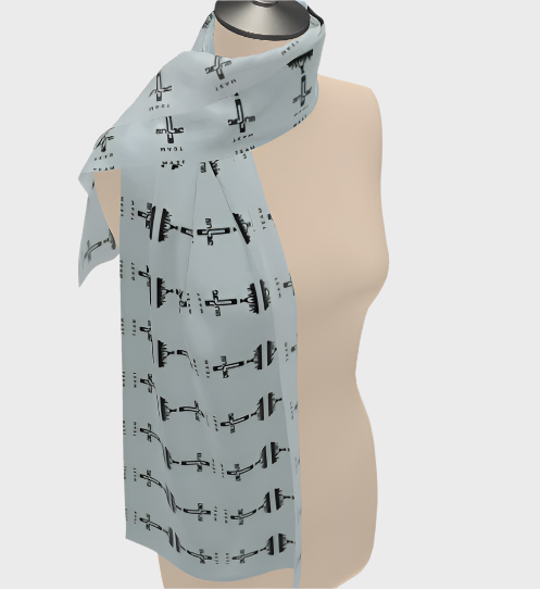 A light blue scarf with a geometric pattern of airplanes displayed on a mannequin.