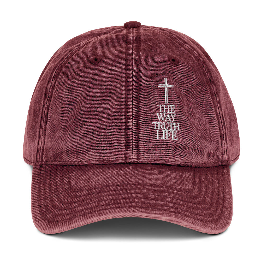 Maroon cap with cross and 'The Way Truth Life' text on a white background
