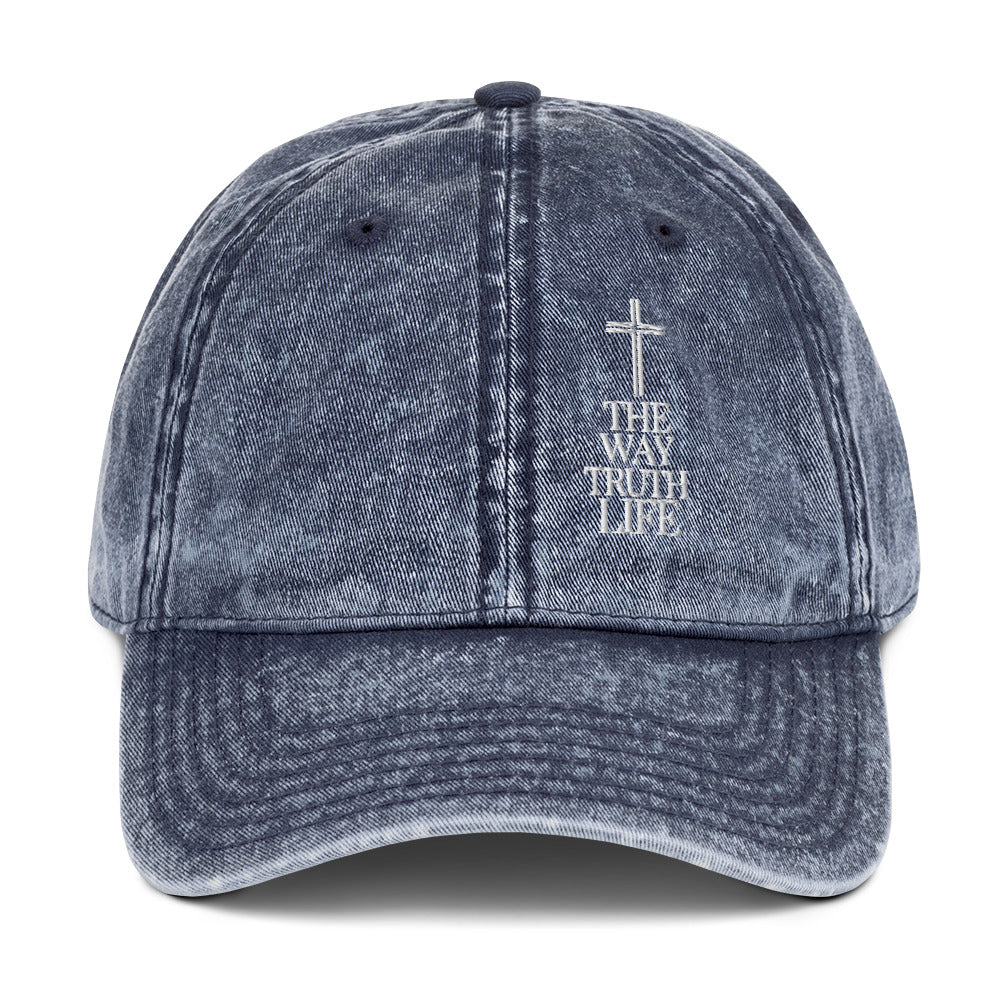 Blue denim cap with cross and 'The Way Truth Life' text on a white background