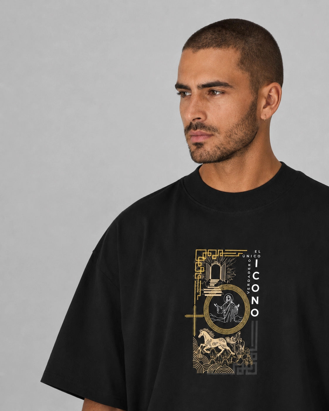 Man wearing a black t-shirt with a gold graphic design on a gray background