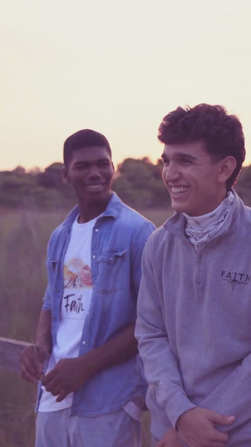 Two young men in modern faith apparel laughing in the park 