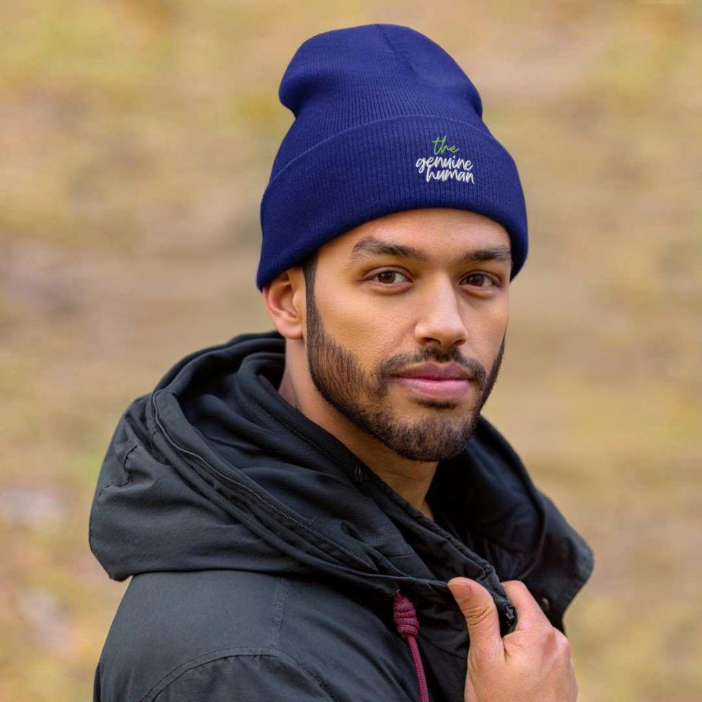 Man wearing blue coloured beanie hat with text thegenuinehuman
