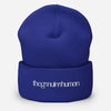 Blue beanie with white text on a white background